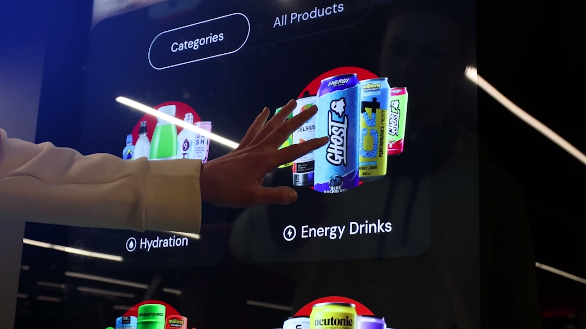 Shopper reaching for a Ghost energy drink on a Bright.Blue screen